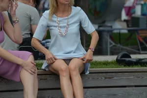 Blonde milf upskirted showing white panties and some pubes