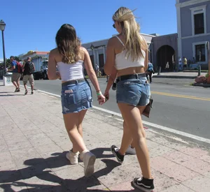 Three sexy friends in denim shorts and a skirt