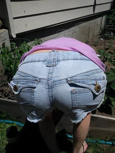 Girl Bending Over in a Garden - Dowblouse and Ass in Denim Shorts