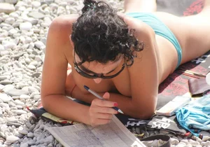 Cute brunette lady topless at the beach with awesome tits