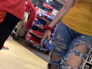 Bunch of girls in various outfits at a Cardinals baseball game