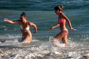 Sexy beach girl in bikini with her other sexy friend