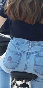 Teen girl in jeans on a bike