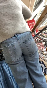 Booty in Bow Bottom Blue Jeans Bends Over, Closeup From Below