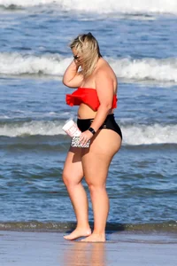 Thick BBW blonde lady in a bikini at the beach