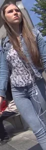 Another girl in tight jeans waiting for the bus