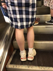 Fit Legs in White Socks and Sneakers on an Escalator Photos
