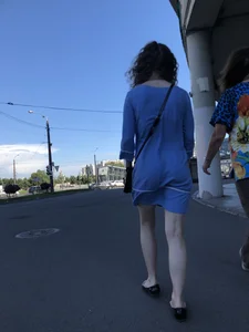 Girl in a Blue Dress With Pale Legs Walking Down the Street - Strong Wind Making Her Panty Line Visible