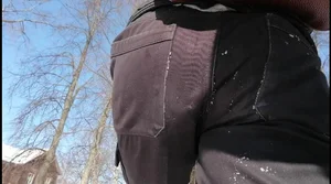 Closeup of a teen's booty in black jeans on the street