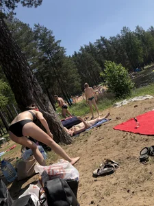 Skinny Girl in Swimsuit Lying on the Lake Beacg Topless and Bending Over