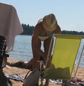 Swedish beach blonde girl in white and green bikini