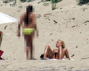 Small boobed topless milf on the beach