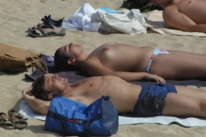 Topless girls on a beach in Barcelona