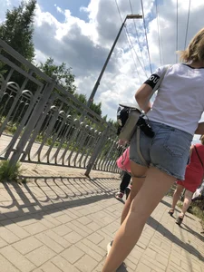 Cute Girl in Denim Shorts Walking Down a Railway Station Gallery