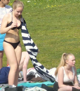 Teen taking off her dress in the park