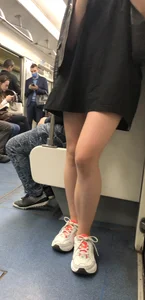 Blonde in a Dress and Sneakers With Sexy Skinny Legs in the Subway Train and on the Escalator Closeup Candid Photos