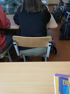 Booty closeup of a candid college girl sitting at her desk in class