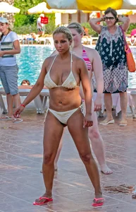 Big boobed blonde milf dancing by the pool in a bikini