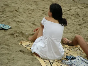 Sexy girl in a blue floral thong bikini at the beach