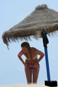 Hot beach girl undressing and going topless