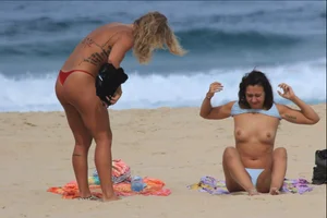 Sexy girls topless on a nude beach showing their nice tits