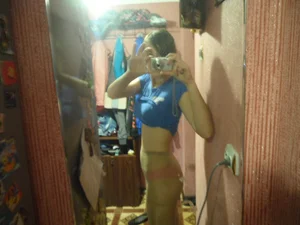 Skinny Girl in a Jerked Up T-Shirt And Pantyhose And With Pink Panties Underneath Mirror Selfie