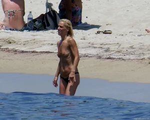 Small boobed topless milf on the beach