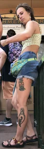 Tatted up hippie in short jean shorts with a nip slip