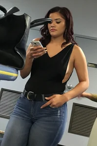 Thick brunette in tight jeans and showing some side boob