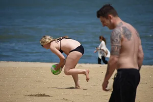 Chunky blonde in a black bikini on the beach