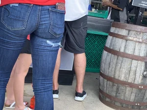 Bunch of girls in various outfits at a Cardinals baseball game