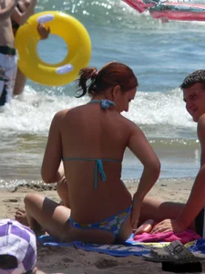 A bunch of hot babes on the beach in thong bikinis