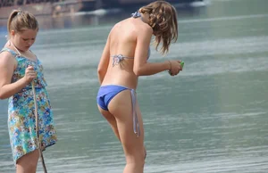 Skinny teen having fun in her little England bikini
