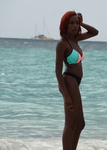 Candid black family, milf and teens on the beach in bikinis