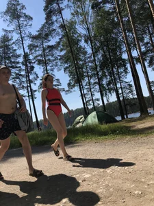 Young Girl in a One-Piece Swimsuit Walking on a Forest Road Photo Gallery