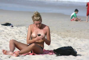 Sexy girls topless on a nude beach showing their nice tits