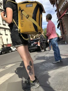 Amazing cute candid food delivery girl with lots of tattoos crossing the street