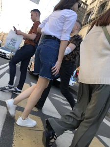 Candid girl wearing denim shorts crossing the street, sexy slim legs
