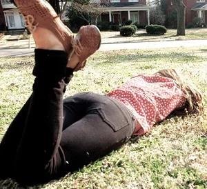 Teen Candid Girl in Tight Black Jeans Lying on the Grass