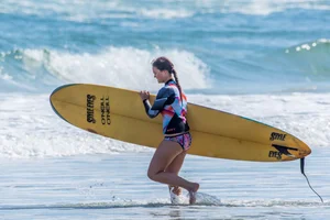 Candid girls surfing on the beach