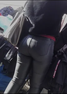 Milf shows off her shapely ass in her leather pants at the market