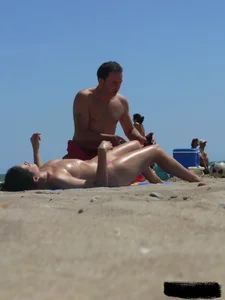 Purple thong topless lady on the beach gets oiled up by her husband