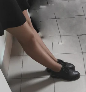 Slim Legs of a College Teen in a Skirt, Pantyhose And Shoes Standing in the Hallway Sneaky Photos