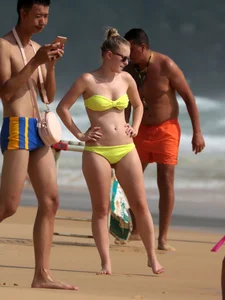 Big booty white girl in a yellow bikini at the beach