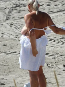 Mature blonde lady on a nude beach with big boobs