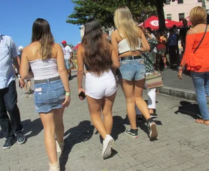 Three sexy friends in denim shorts and a skirt