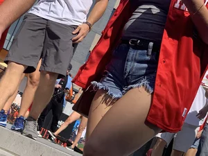 Bunch of girls in various outfits at a Cardinals baseball game