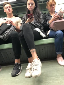 Girl with Tattooed Legs Sitting in Subway Train Creepshot