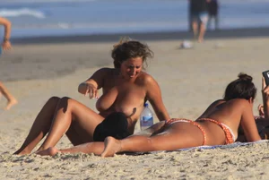 Sexy girls topless on a nude beach showing their nice tits