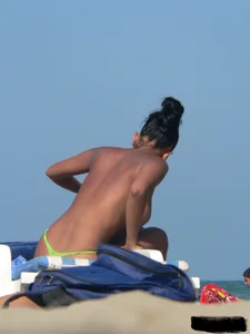 Hot ass topless beach girl with great tits lets her little brother oil up her ass in thong bikini